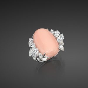 Single Angel Skin Coral Oval Cabochon 25.6 x 16.1 x 8.1mm set in an 18K White Gold Ring with 10 Diamonds, 3.86 cts