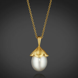 A magnificent South Sea Cultured Pearl Drop, approximately 17.0 X 14.0mm, is topped with “petals” of 18K Yellow Gold. 16” chain.